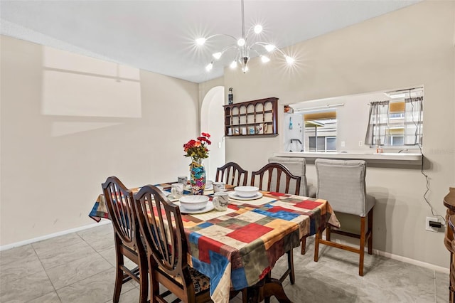 732 Kensington Lake Cir, Brandon, FL 33511 - dining area featuring baseboards, a chandelier, arched walkways, and light tile patterned floors