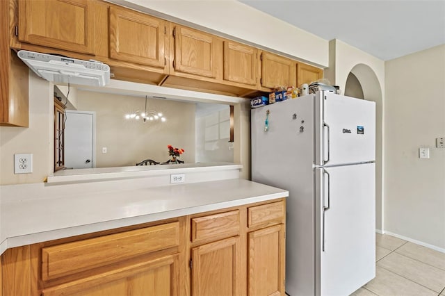732 Kensington Lake Cir, Brandon, FL 33511 - kitchen with freestanding refrigerator, light tile patterned floors, light countertops, and a chandelier