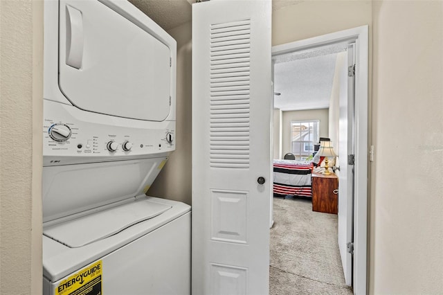 732 Kensington Lake Cir, Brandon, FL 33511 - laundry room with stacked washer / drying machine, carpet floors, and a textured ceiling