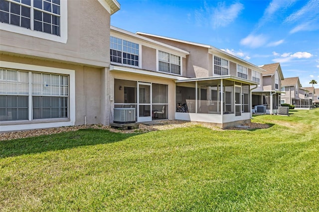 732 Kensington Lake Cir, Brandon, FL 33511 - rear view of property with a sunroom, stucco siding, a yard, and cooling unit