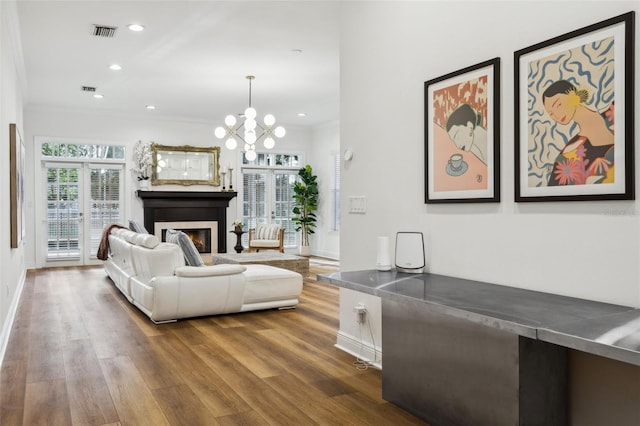 living area with dark wood-style floors, a chandelier, a glass covered fireplace, baseboards, and recessed lighting