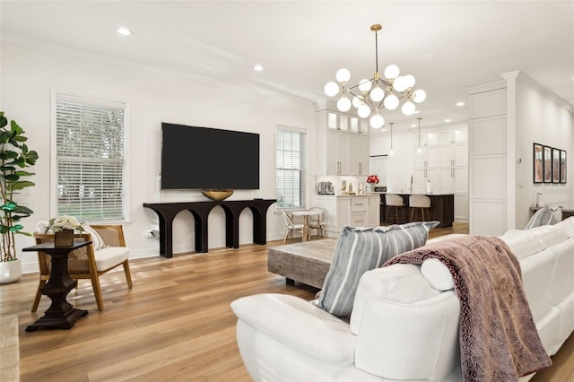 living area featuring ornamental molding, a chandelier, light wood finished floors, recessed lighting, and baseboards