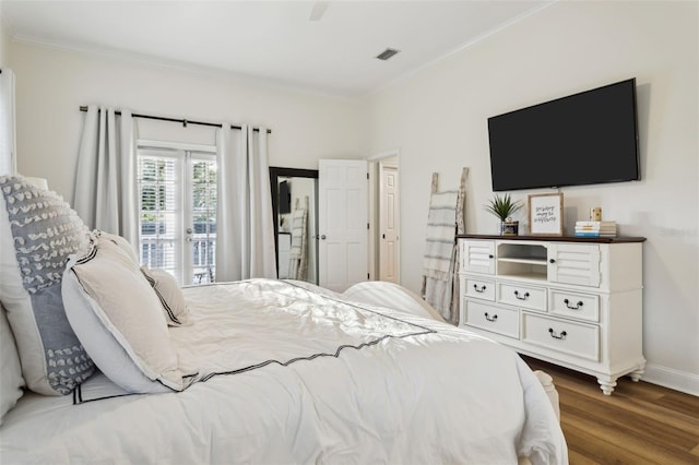bedroom featuring crown molding, wood finished floors, access to exterior, and baseboards