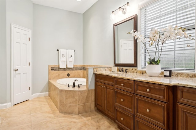 bathroom featuring a bath, tile patterned floors, plenty of natural light, and vanity
