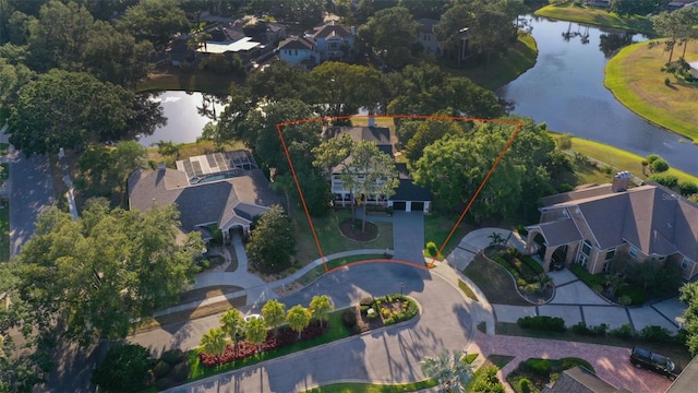 aerial perspective of suburban area featuring a large body of water and property boundaries highlighted