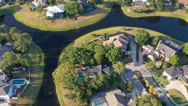 aerial view of property and surrounding area with nearby suburban area and a large body of water