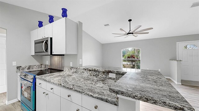 2675 Cherokee St, North Port, FL 34286 - kitchen with appliances with stainless steel finishes, ceiling fan, light wood-style floors, light stone countertops, and white cabinetry