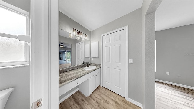 2675 Cherokee St, North Port, FL 34286 - bathroom with wood finished floors, baseboards, and vanity