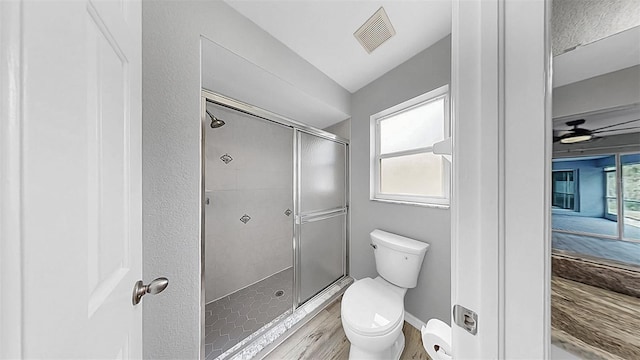 2675 Cherokee St, North Port, FL 34286 - bathroom with a shower stall, toilet, and wood finished floors