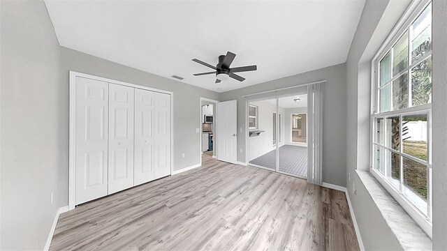 2675 Cherokee St, North Port, FL 34286 - unfurnished bedroom featuring light wood-style floors, baseboards, a closet, a ceiling fan, and ensuite bathroom