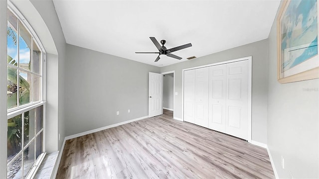 2675 Cherokee St, North Port, FL 34286 - unfurnished bedroom with wood finished floors, baseboards, a closet, and a ceiling fan