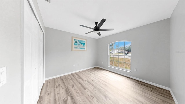 2675 Cherokee St, North Port, FL 34286 - unfurnished bedroom featuring light wood finished floors, a closet, baseboards, and ceiling fan