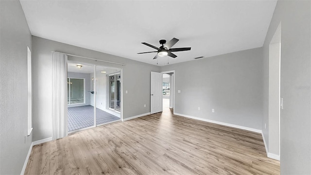 2675 Cherokee St, North Port, FL 34286 - unfurnished bedroom featuring wood finished floors, baseboards, ceiling fan, and access to outside