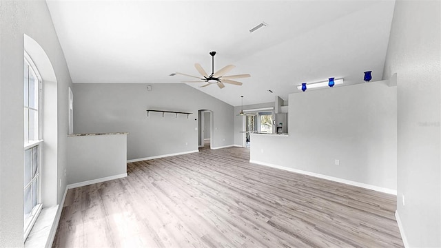 2675 Cherokee St, North Port, FL 34286 - unfurnished living room featuring a ceiling fan, light wood-style floors, lofted ceiling, baseboards, and arched walkways