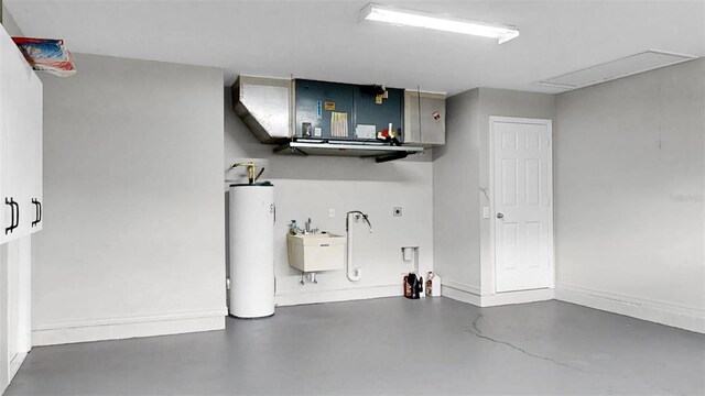 2675 Cherokee St, North Port, FL 34286 - garage with water heater, a sink, and baseboards