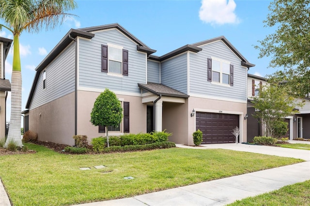 view of front of property featuring a front yard, a garage, stucco siding, and driveway