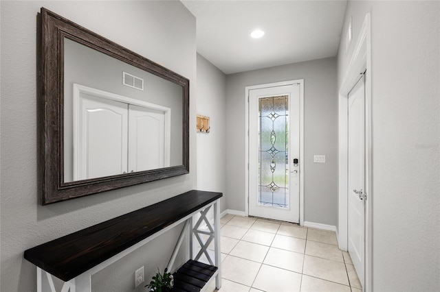 doorway to outside featuring baseboards, recessed lighting, light tile patterned floors, and visible vents