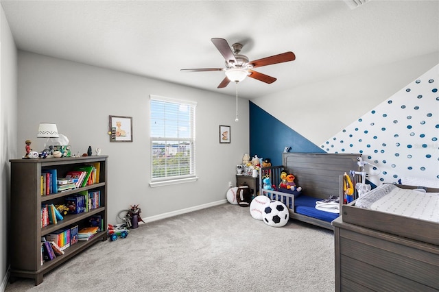 carpeted bedroom with lofted ceiling, baseboards, and a ceiling fan