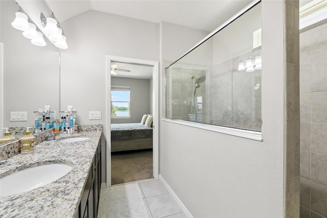 bathroom with tile patterned floors, connected bathroom, a sink, and a walk in shower