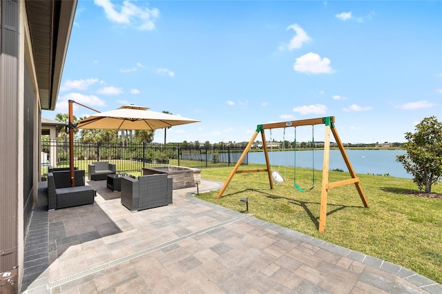 view of play area featuring a yard, a water view, an outdoor hangout area, and a patio