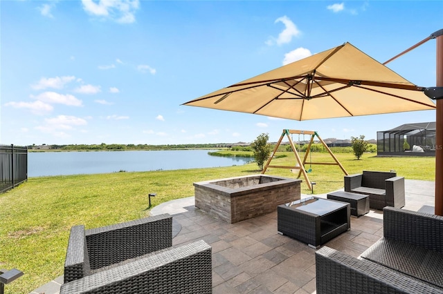 view of patio featuring an outdoor living space with a fire pit and a water view