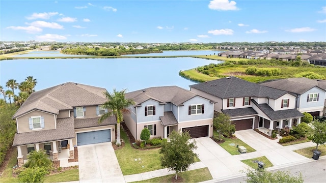 birds eye view of property with a water view and a residential view