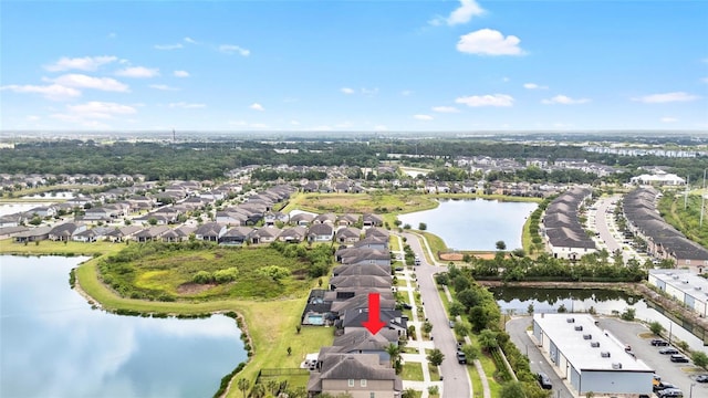 drone / aerial view with a water view and a residential view