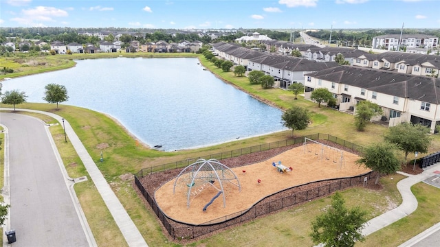 drone / aerial view with a water view and a residential view