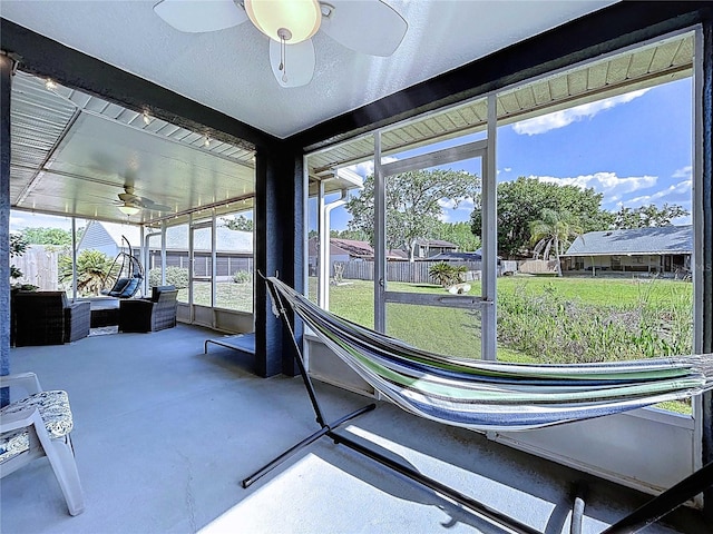 sunroom / solarium with a ceiling fan