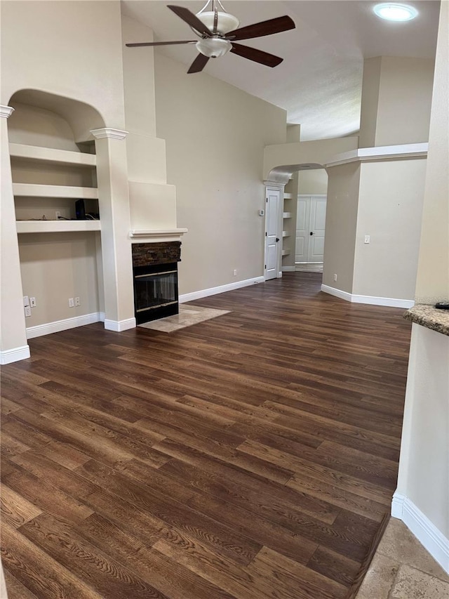 1608 Fox Glen Ct, Winter Springs, FL 32708 - unfurnished living room with high vaulted ceiling, a fireplace with flush hearth, baseboards, arched walkways, and ceiling fan