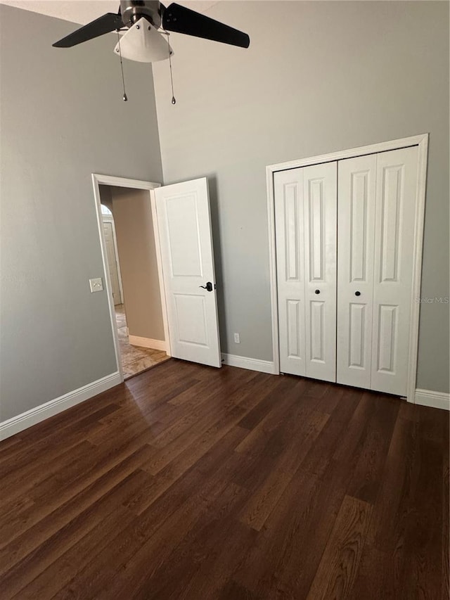 1608 Fox Glen Ct, Winter Springs, FL 32708 - unfurnished bedroom with a closet, dark wood-type flooring, ceiling fan, a high ceiling, and baseboards