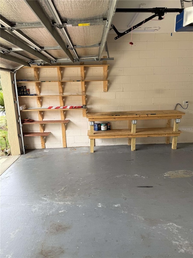 1608 Fox Glen Ct, Winter Springs, FL 32708 - garage with concrete block wall, a garage door opener, and a workshop area