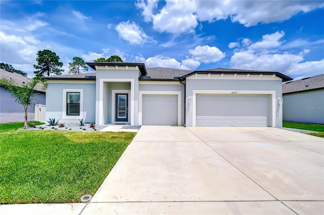 18657 Obregan Dr, Spring Hill, FL 34610 - prairie-style home with a garage, concrete driveway, stucco siding, and a front lawn
