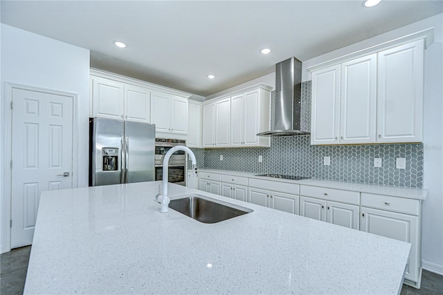 18657 Obregan Dr, Spring Hill, FL 34610 - kitchen featuring stainless steel appliances, wall chimney range hood, a sink, white cabinets, and backsplash