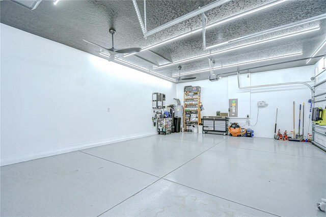18657 Obregan Dr, Spring Hill, FL 34610 - garage with electric panel, water heater, and a garage door opener
