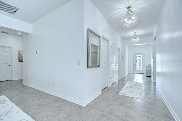 18657 Obregan Dr, Spring Hill, FL 34610 - entryway with a chandelier, light tile patterned floors, and baseboards