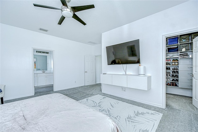 18657 Obregan Dr, Spring Hill, FL 34610 - carpeted bedroom with a spacious closet, a closet, ensuite bath, baseboards, and ceiling fan