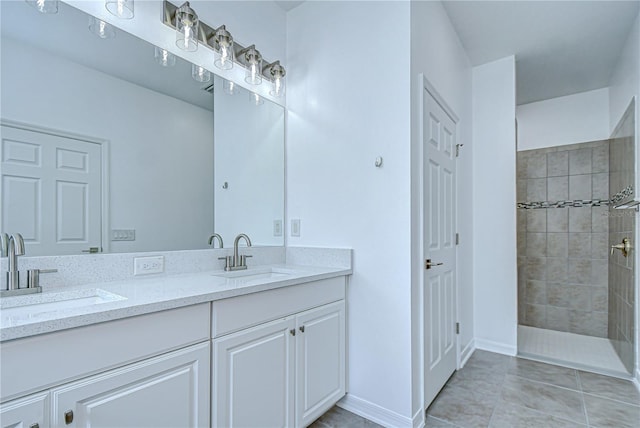 18657 Obregan Dr, Spring Hill, FL 34610 - bathroom with double vanity, tiled shower, tile patterned floors, and baseboards
