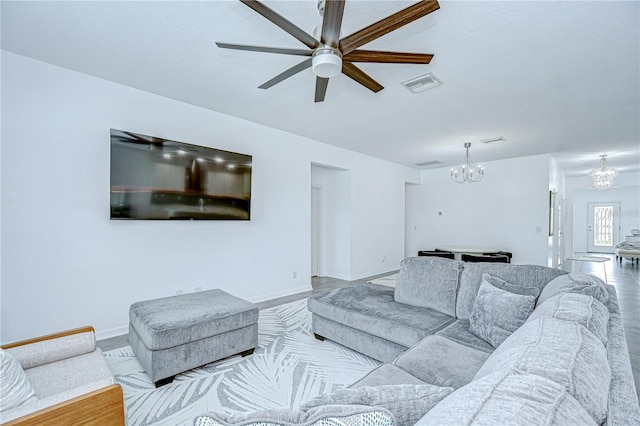 18657 Obregan Dr, Spring Hill, FL 34610 - living area featuring a chandelier, a ceiling fan, and baseboards