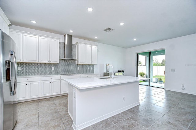 18657 Obregan Dr, Spring Hill, FL 34610 - kitchen with wall chimney exhaust hood, a sink, stainless steel fridge with ice dispenser, black electric cooktop, and white cabinets