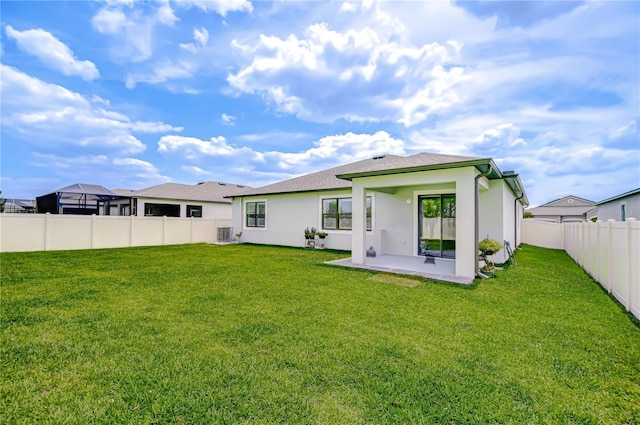 18657 Obregan Dr, Spring Hill, FL 34610 - back of property with a patio area, stucco siding, central AC, and roof with shingles