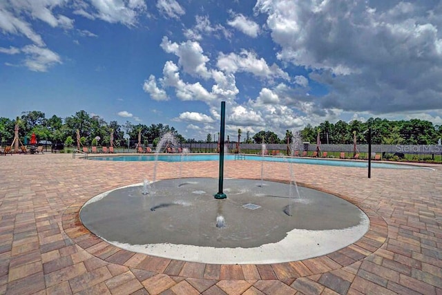 18657 Obregan Dr, Spring Hill, FL 34610 - view of property's community with a swimming pool and a patio