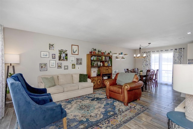 living room with wood finished floors and a notable chandelier