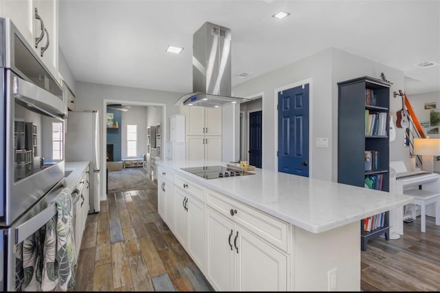 kitchen with white cabinetry, dark wood-type flooring, island range hood, and black electric stovetop