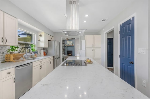 kitchen featuring stainless steel dishwasher, visible vents, island exhaust hood, decorative backsplash, and black electric cooktop