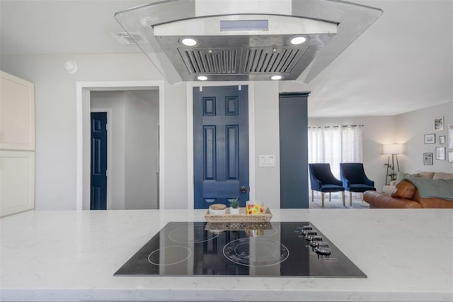kitchen with black electric cooktop, light stone countertops, open floor plan, and visible vents