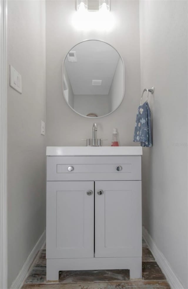 bathroom featuring baseboards and vanity