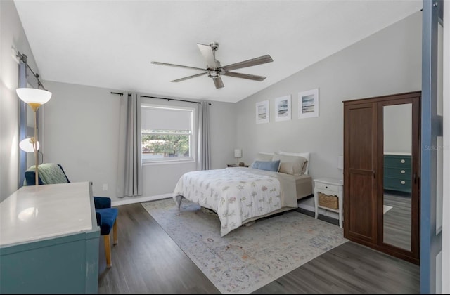 bedroom with dark wood-style flooring, lofted ceiling, baseboards, and ceiling fan