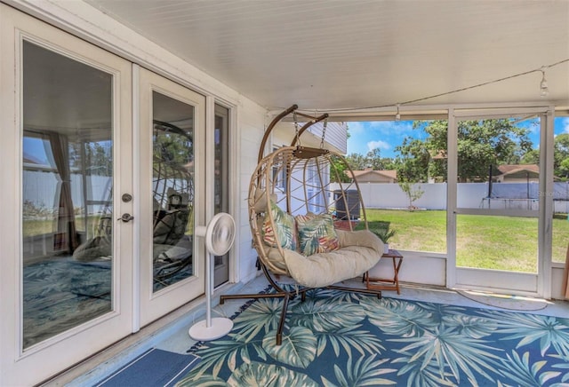 sunroom / solarium featuring french doors