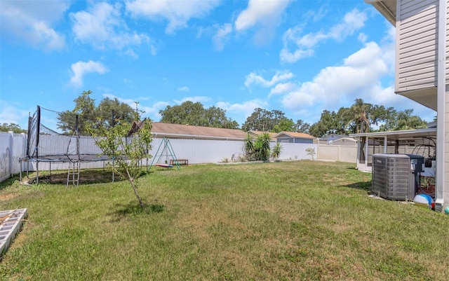 view of yard featuring a fenced backyard, a trampoline, and cooling unit